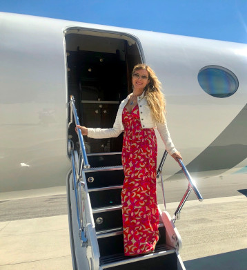 Scarlet boarding a private jet